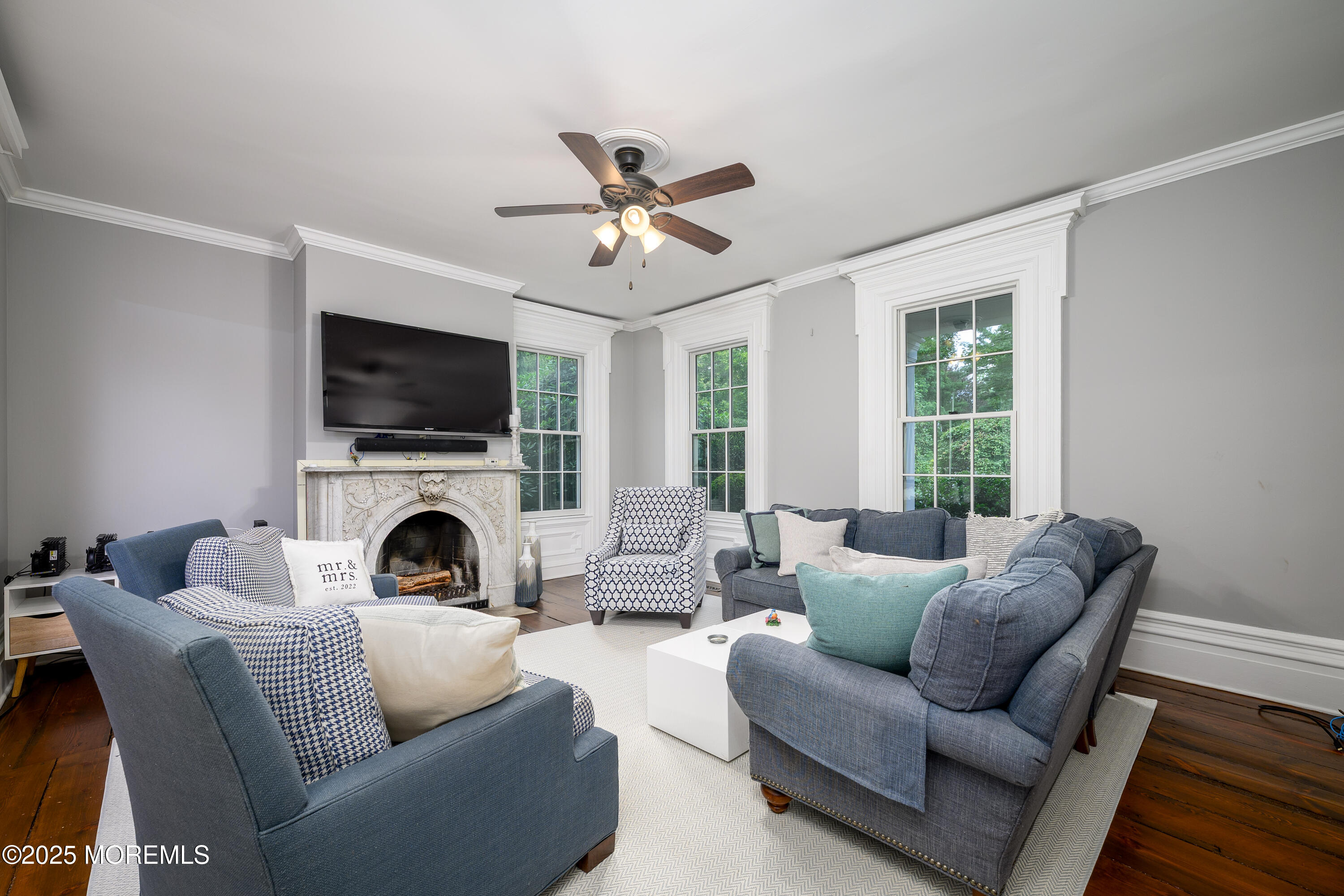 60 Conover Road Colts Neck, NJ 07722 - Photo 9 of 56 a living room with furniture a fireplace and a flat screen tv