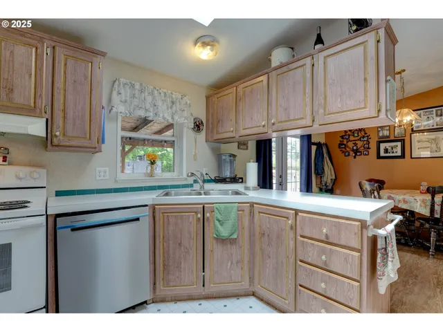 a kitchen with cabinets and window
