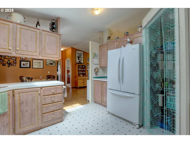 a kitchen with stainless steel appliances granite countertop a refrigerator and a cabinets