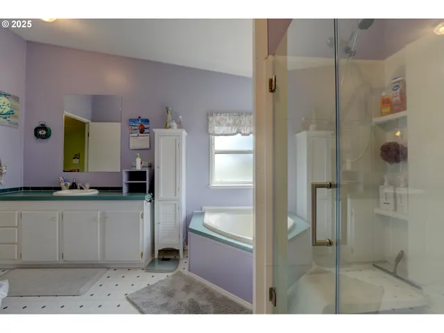 a bathroom with a tub sink and mirror