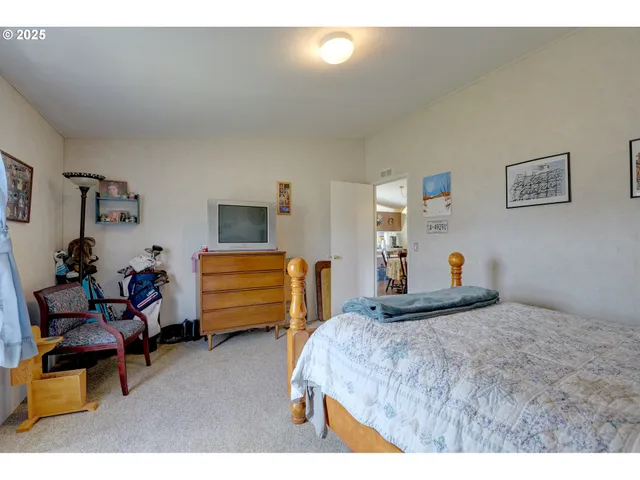 a living room with furniture a flat screen tv and a window