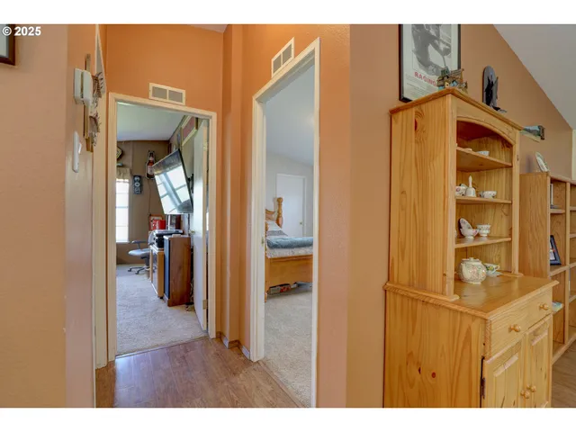 a spacious bedroom with a bed and a chandelier