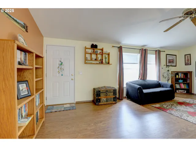 a living room with furniture and a book shelf