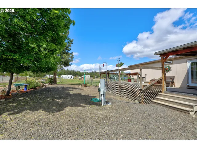 a backyard of a house with table and chairs