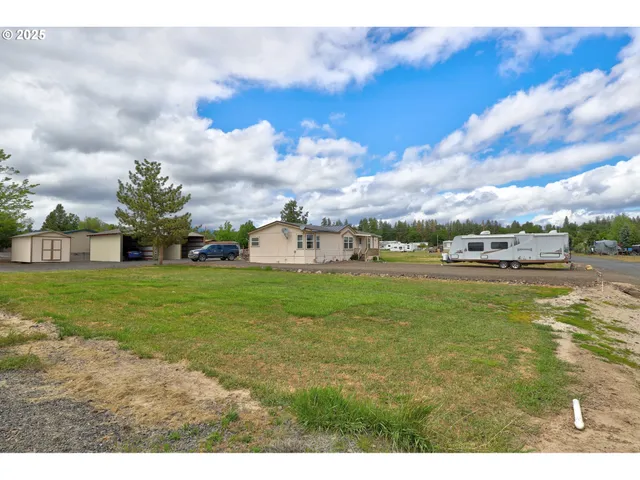 a picture of houses with outdoor space and lake view