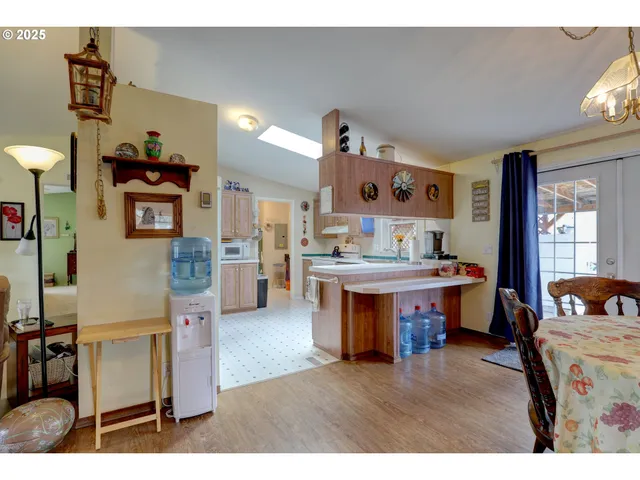 a living room with kitchen island furniture and a wooden floor