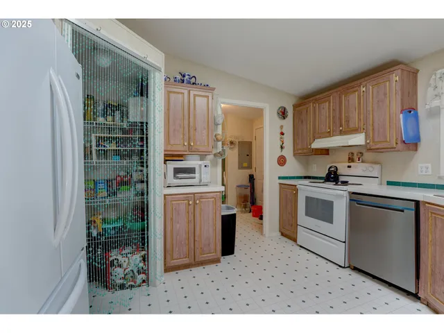 a kitchen with stainless steel appliances granite countertop a refrigerator sink and stove