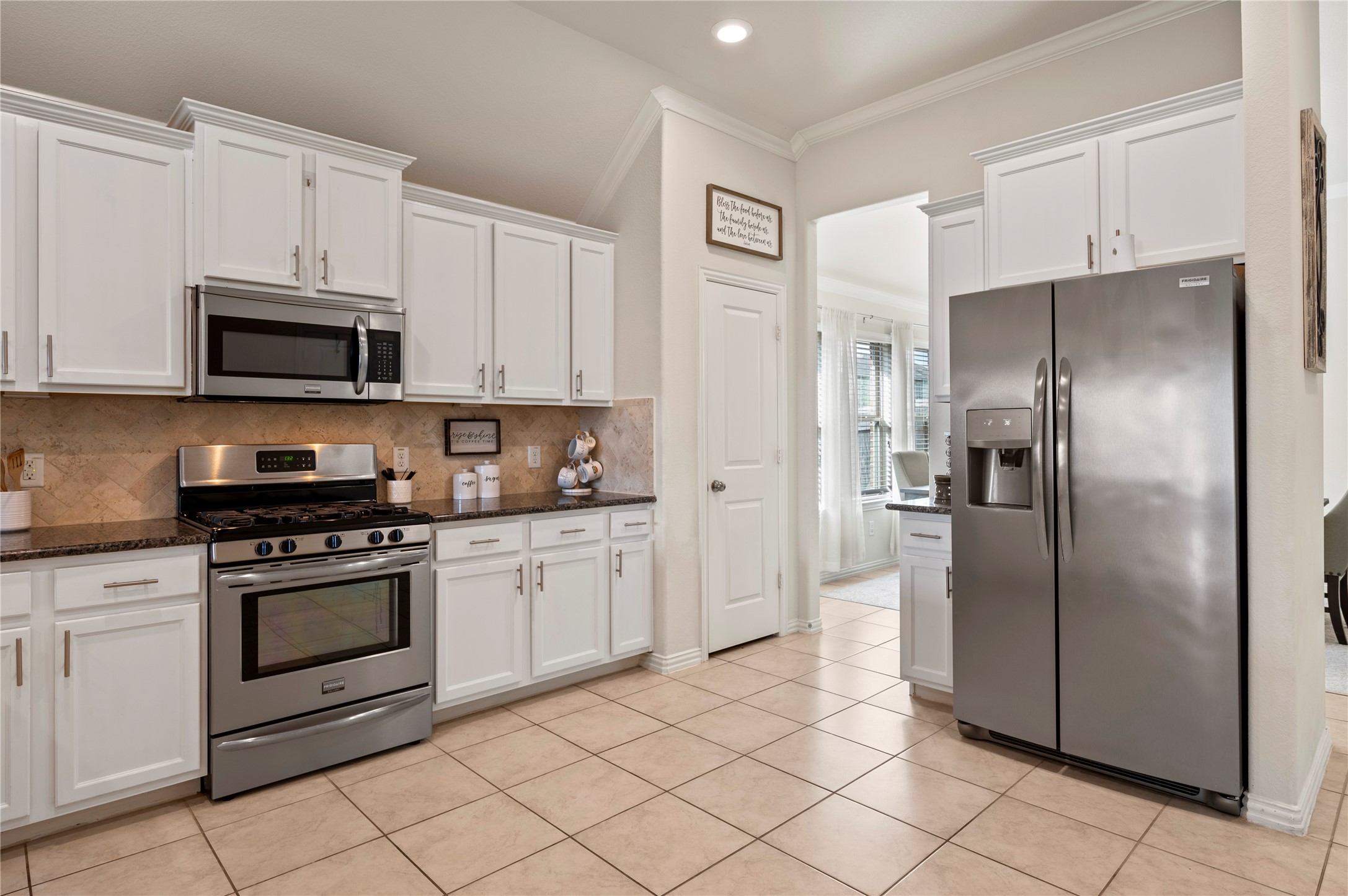 13726 Madera Bend Lane Rosharon, TX 77583 - Photo 12 of 34 a kitchen with stainless steel appliances granite countertop a refrigerator and a stove top oven