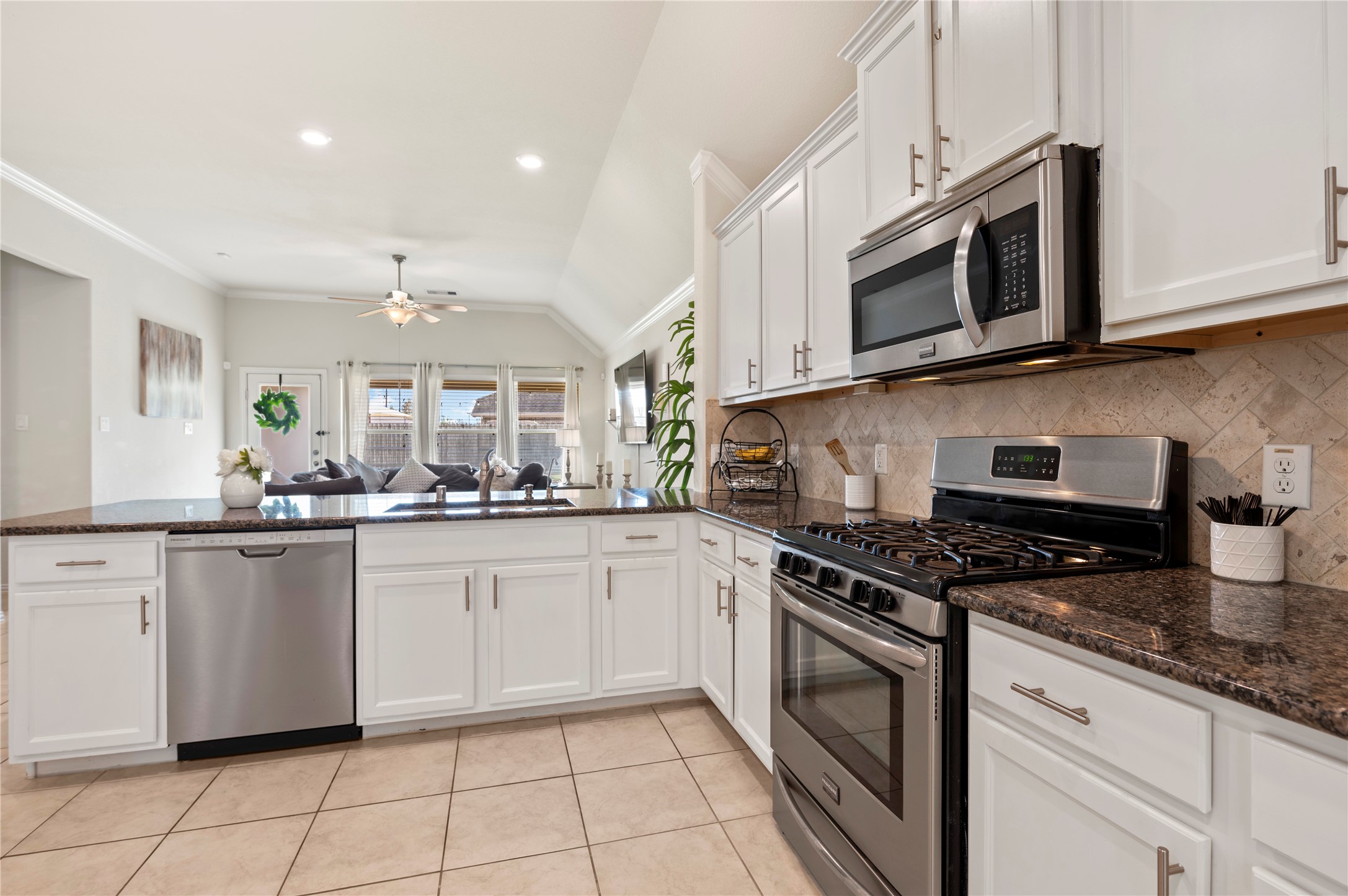 13726 Madera Bend Lane Rosharon, TX 77583 - Photo 13 of 34 a kitchen with granite countertop white cabinets stainless steel appliances and a sink
