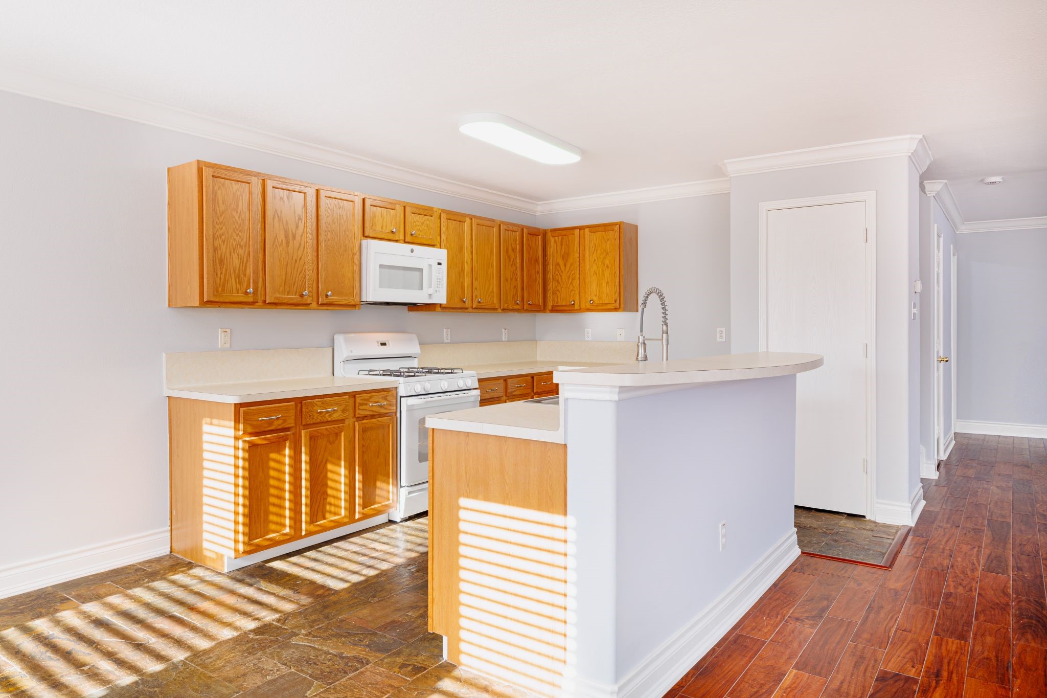 8318 Tartan Court Rosharon, TX 77583 - Photo 6 of 31 Bright kitchen features wooden cabinets, new stainless steel sink, and updated plumbing fixtures.