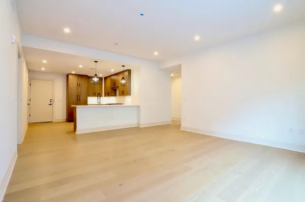 an empty room with windows and closet