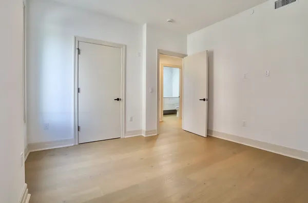 a bathroom with a granite countertop sink mirror and a toilet