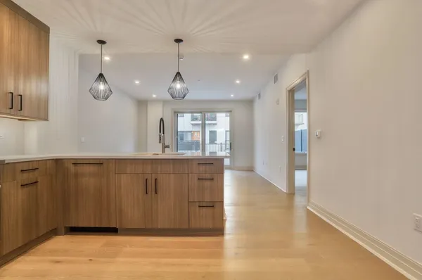 a kitchen with kitchen island white cabinets stainless steel appliances and a sink