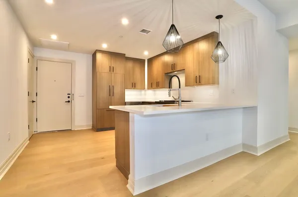 a large room with a large window and kitchen view
