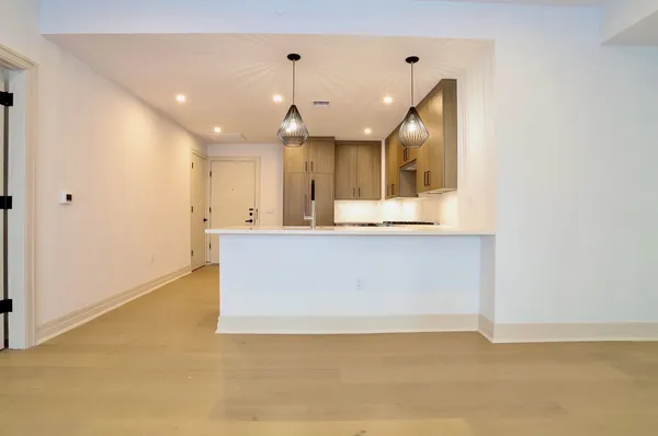 a view of a sink and dishwasher with wooden floor