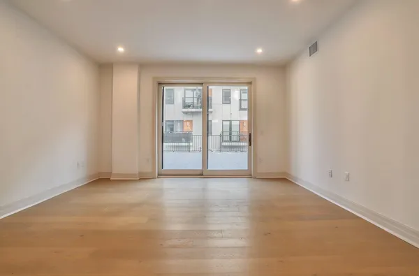 a view of an empty room with glass door