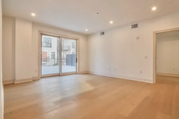 an empty room with a cabinet and mirror
