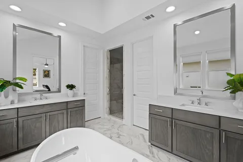 a spacious bathroom with a double vanity sink and a mirror
