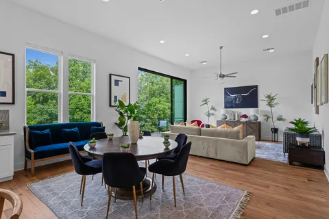 a living room with furniture potted plant a window and a fireplace
