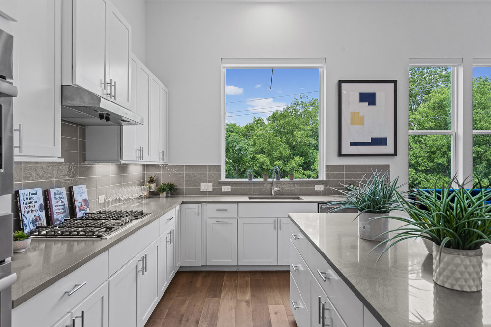 5324 Agatha Circle Austin, TX 78724 - Photo 8 of 34 a kitchen with stainless steel appliances granite countertop a sink a stove and a wooden floors