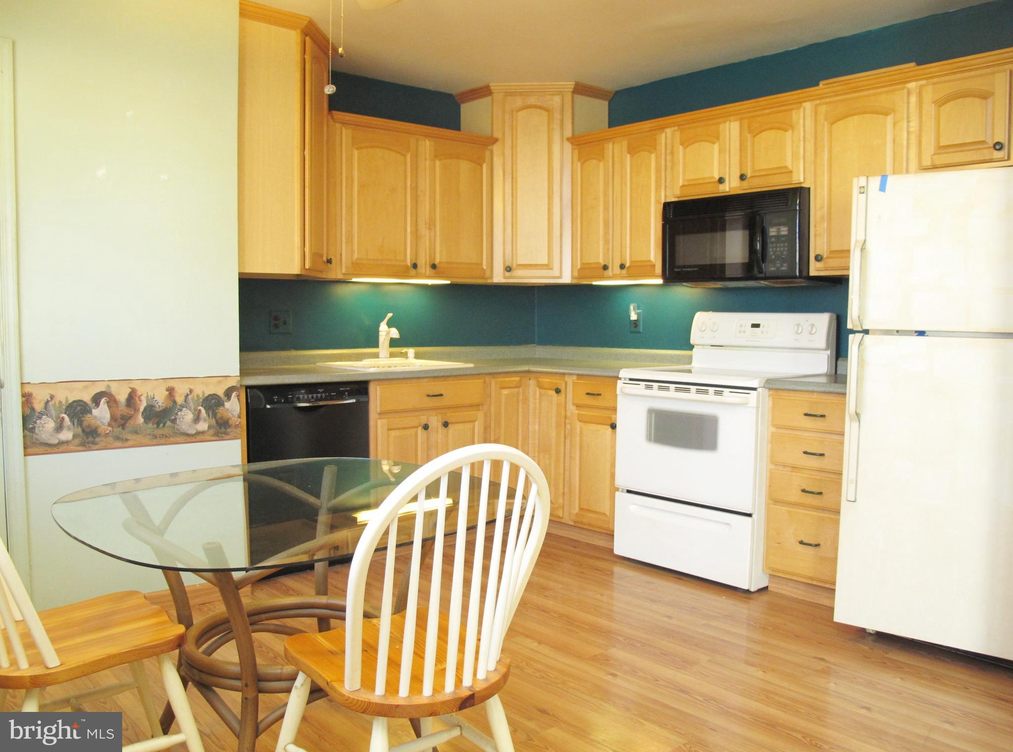 206 Paddock Way Delran, NJ 08075 - Photo 9 of 33 a kitchen with a table chairs microwave and cabinets