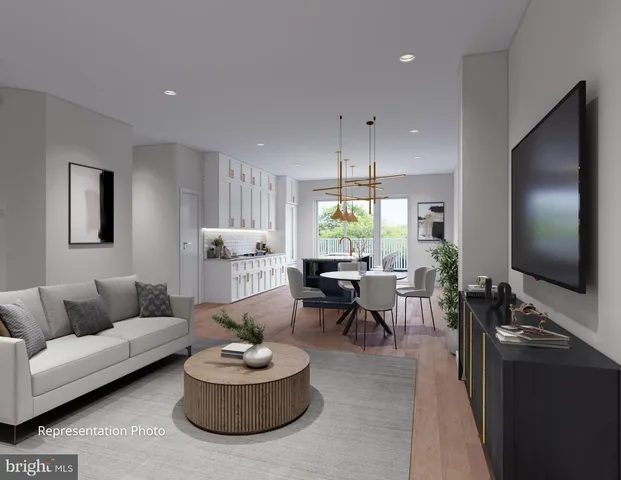 a kitchen with a stove a sink a kitchen island with a dining table and chairs