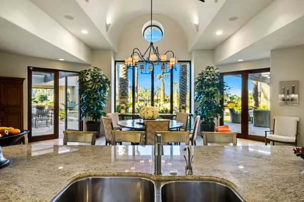 a view of a chairs and table in patio with a fire pit