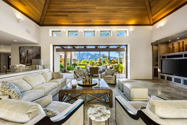 a living room with furniture and a potted plant