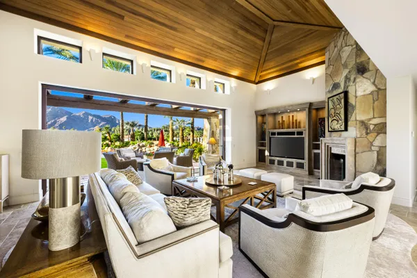 a living room with furniture and a floor to ceiling window