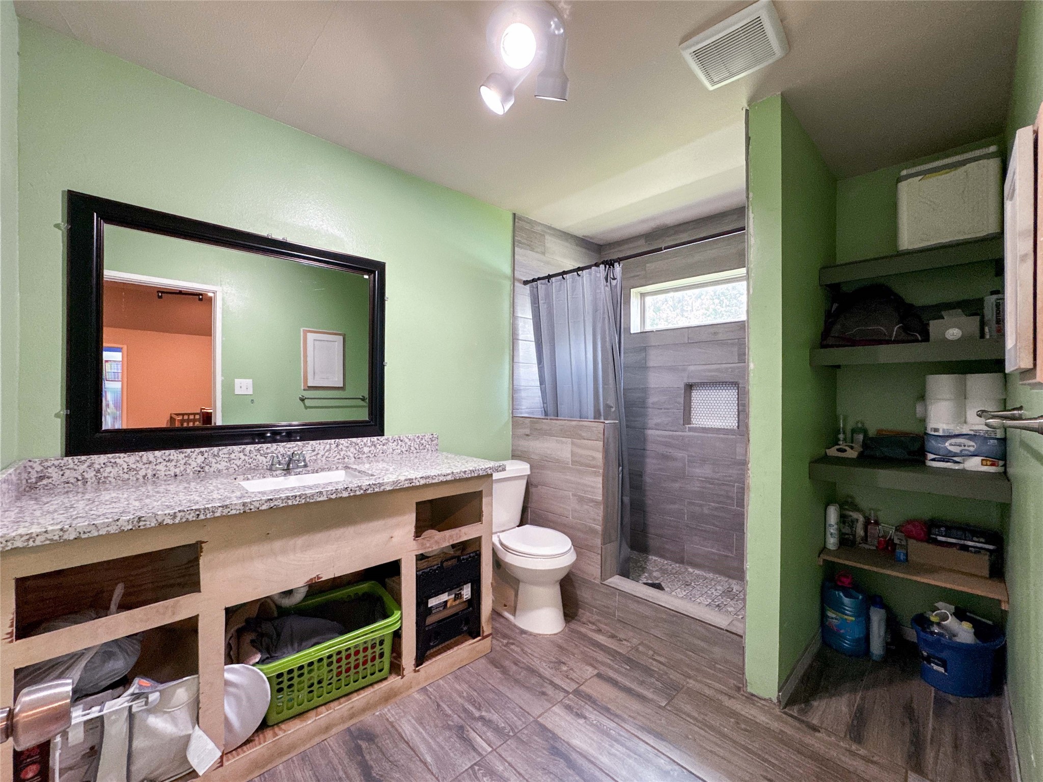 1060 County Road 5021 Cleveland, TX 77327 - Photo 16 of 34 a bathroom with a sink a toilet and mirror