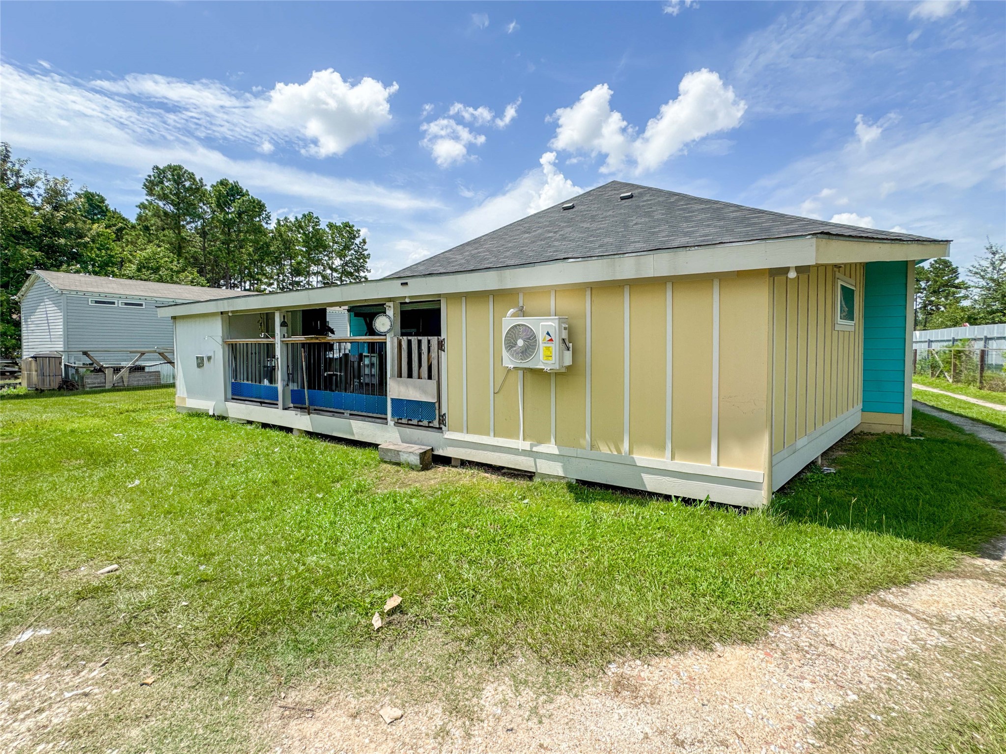 1060 County Road 5021 Cleveland, TX 77327 - Photo 24 of 34 a view of a house with a yard
