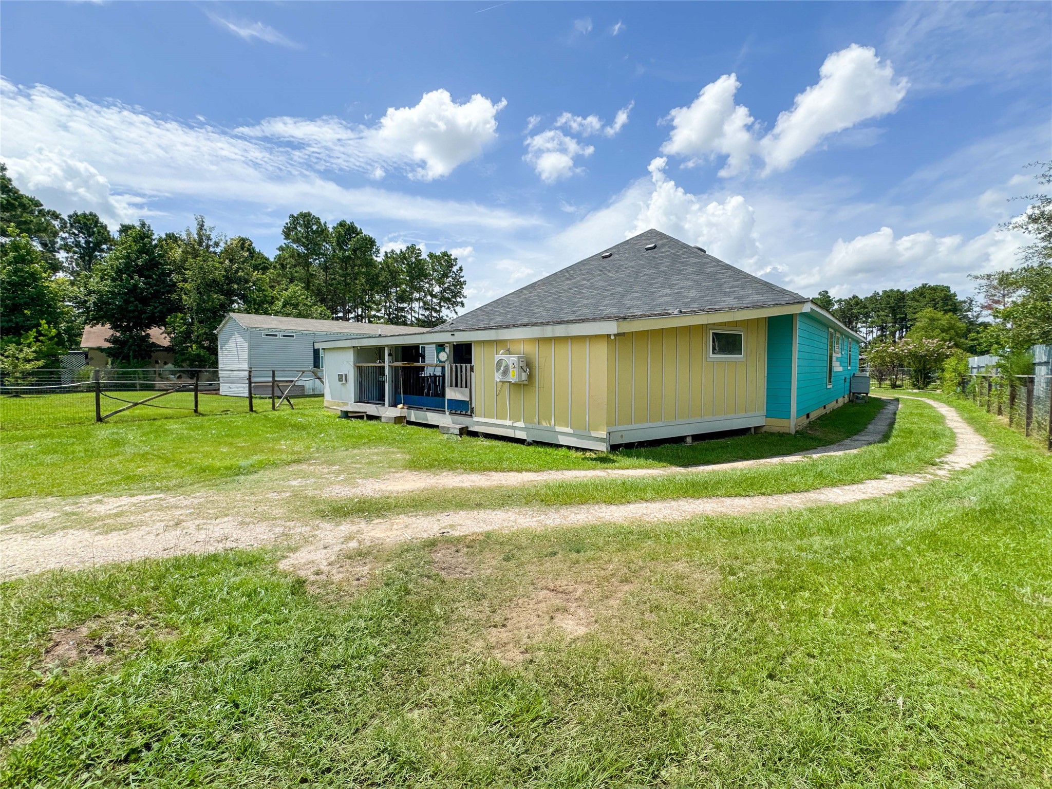 1060 County Road 5021 Cleveland, TX 77327 - Photo 25 of 34 a view of a house with a backyard porch and sitting area