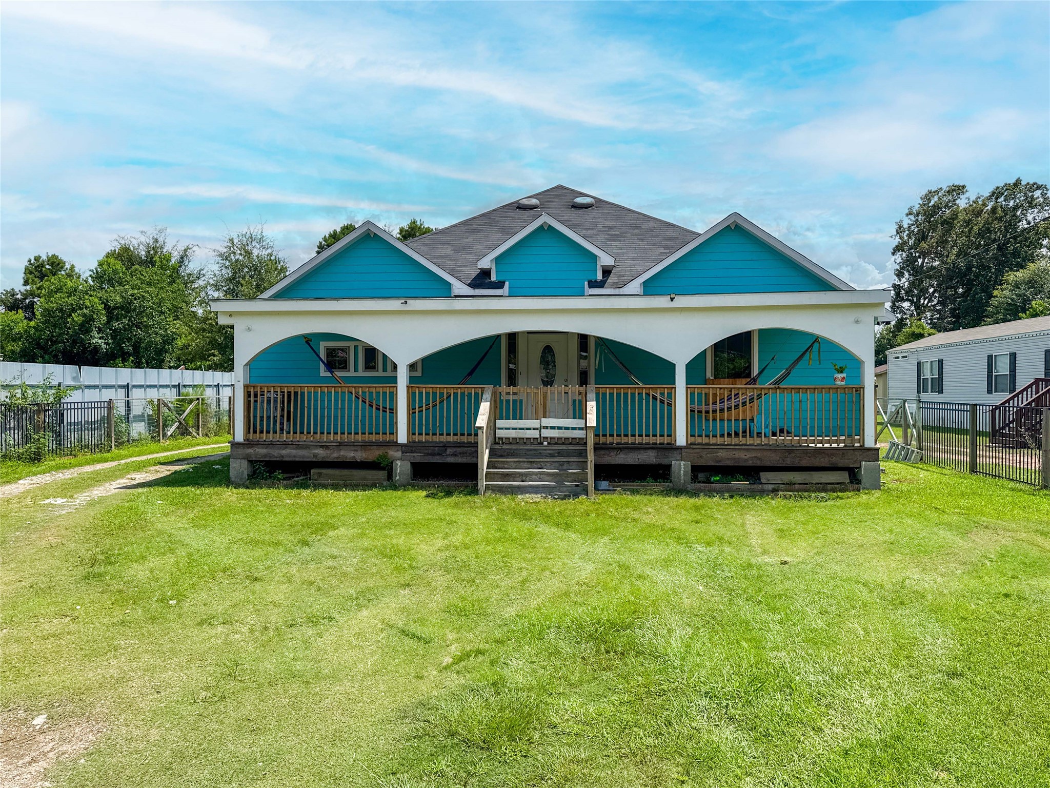 1060 County Road 5021 Cleveland, TX 77327 - Photo 27 of 34 a front view of house with yard and seating area