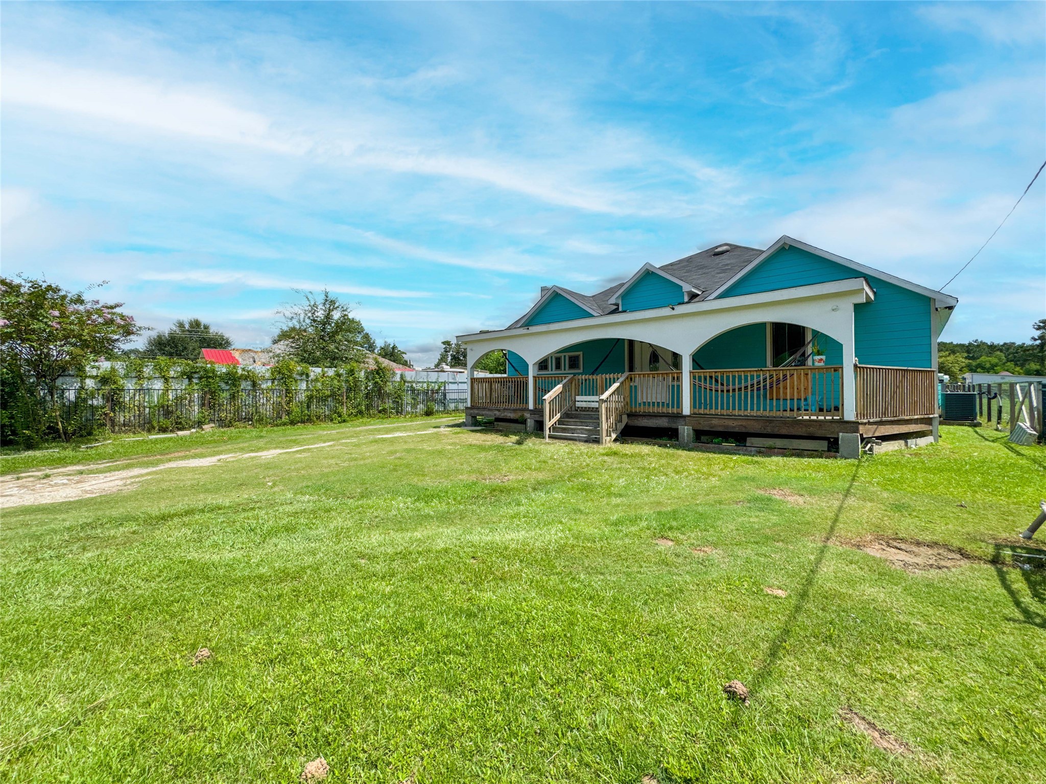 1060 County Road 5021 Cleveland, TX 77327 - Photo 28 of 34 a front view of house with yard and green space