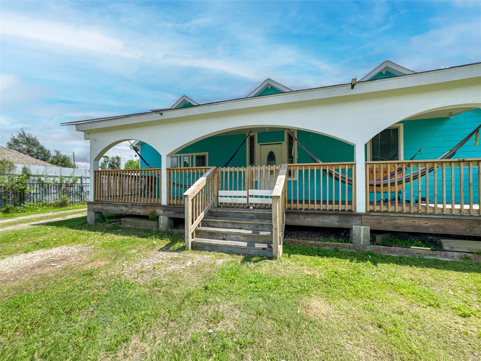 1060 County Road 5021 Cleveland, TX 77327 - Photo 29 of 34 a view of house with a yard and deck area