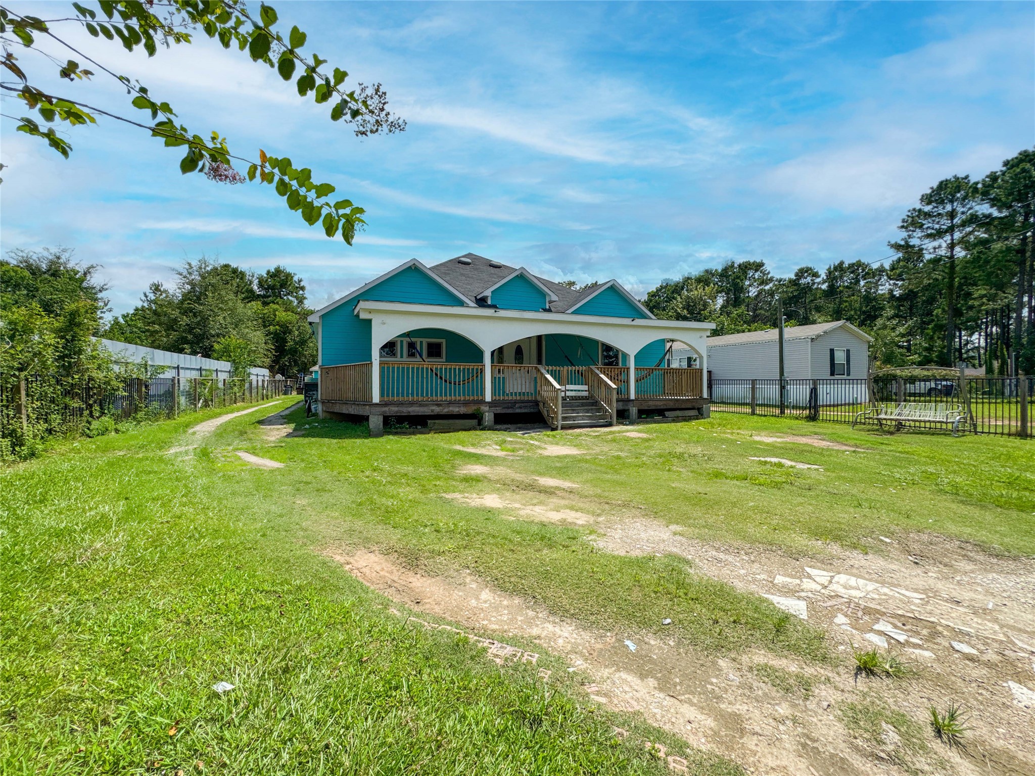 1060 County Road 5021 Cleveland, TX 77327 - Photo 30 of 34 a view of a house with a big yard