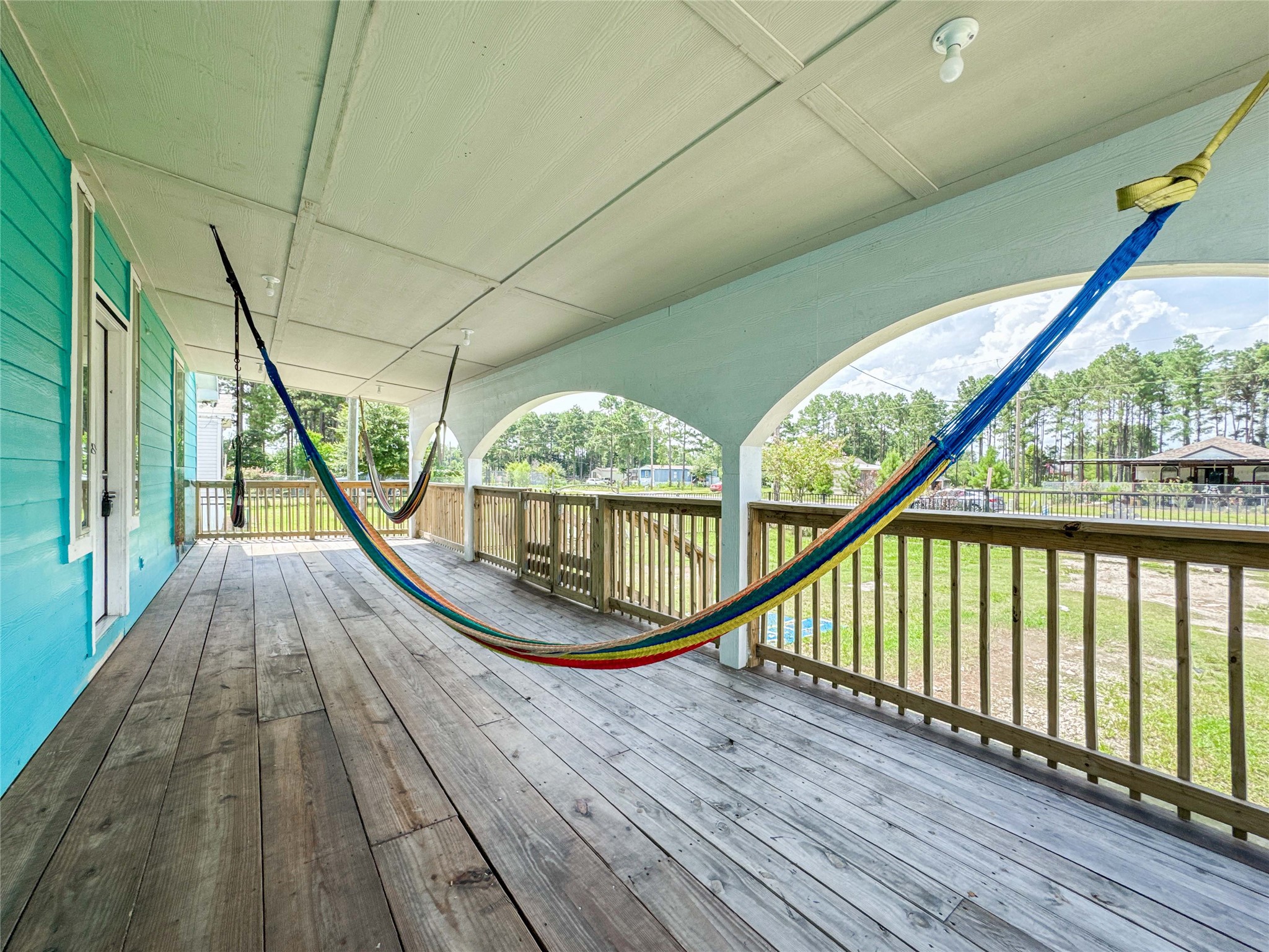 1060 County Road 5021 Cleveland, TX 77327 - Photo 31 of 34 a view of balcony with wooden floor