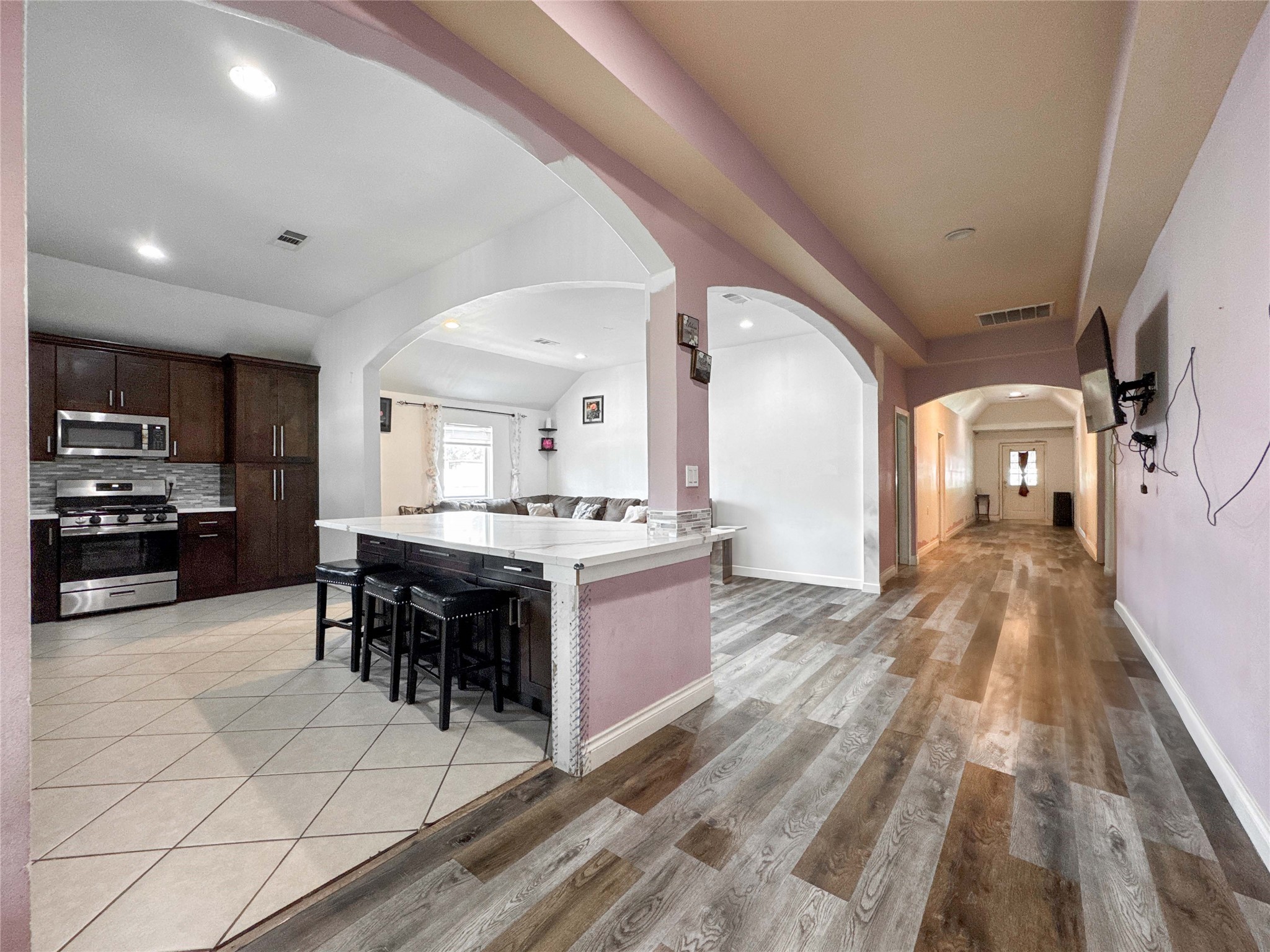 1060 County Road 5021 Cleveland, TX 77327 - Photo 4 of 34 a large white kitchen with a large window and stainless steel appliances