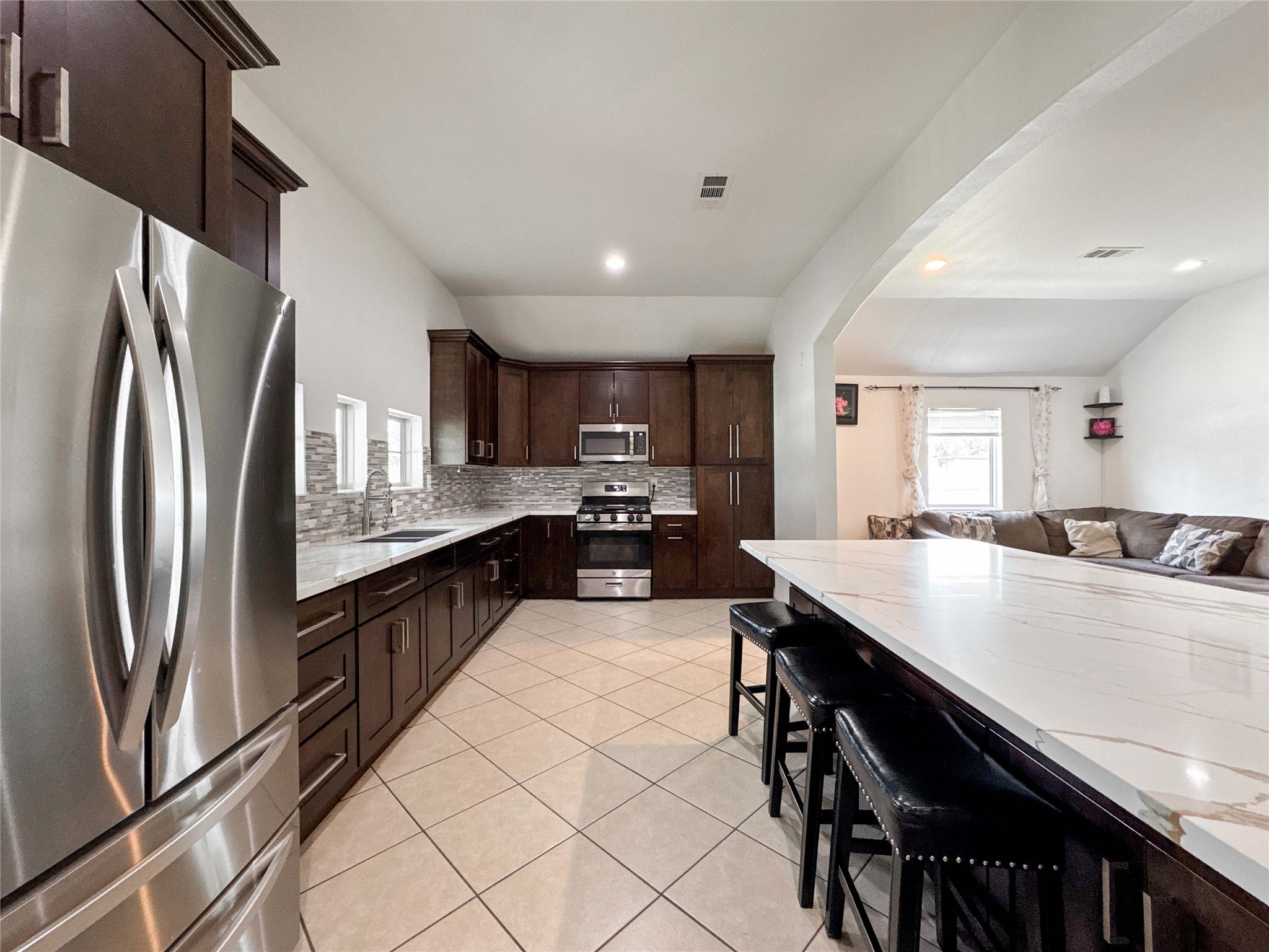 1060 County Road 5021 Cleveland, TX 77327 - Photo 5 of 34 a large kitchen with a large counter top appliances and cabinets