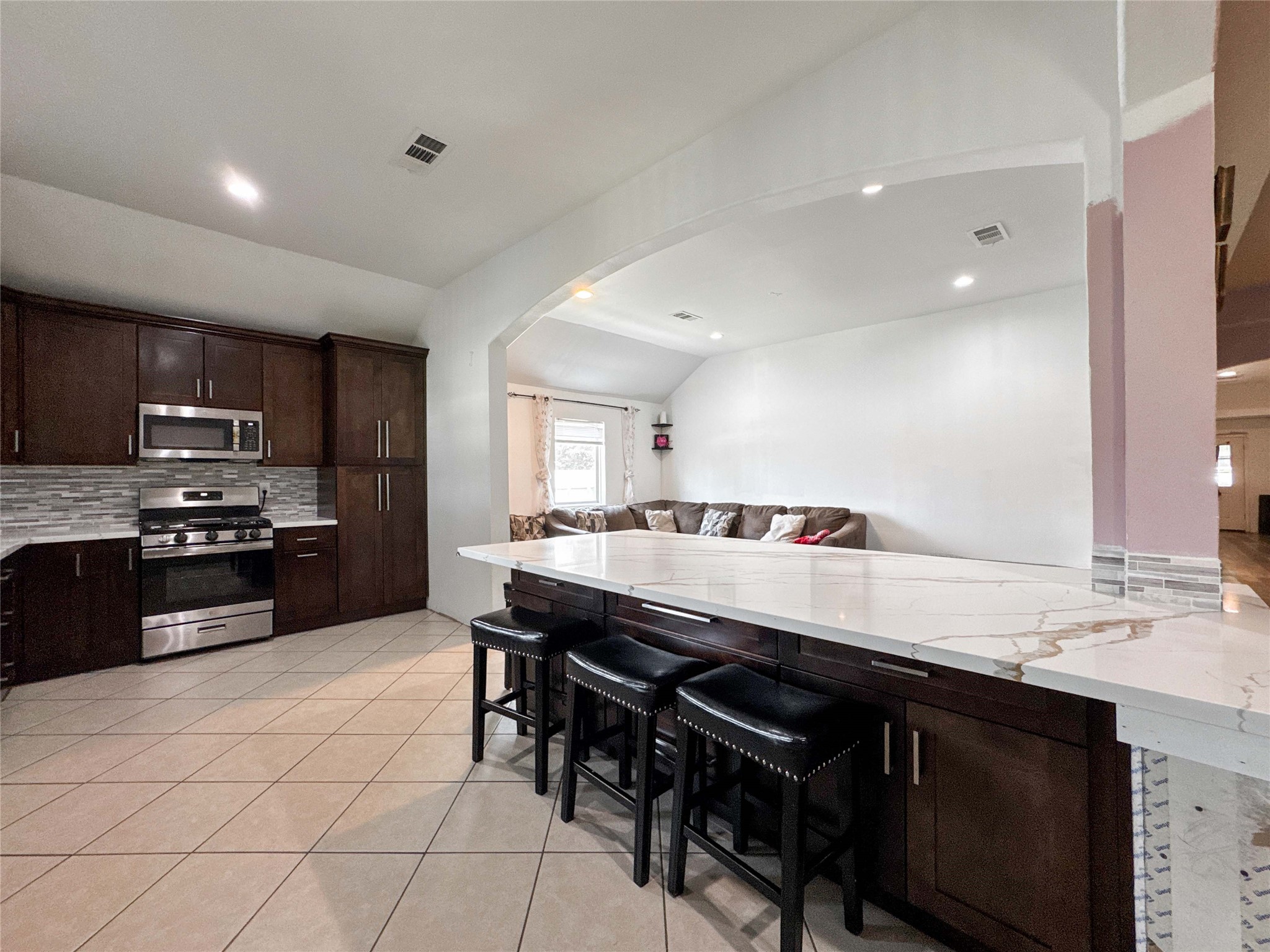 1060 County Road 5021 Cleveland, TX 77327 - Photo 6 of 34 a kitchen with a sink a stove a counter space and cabinets