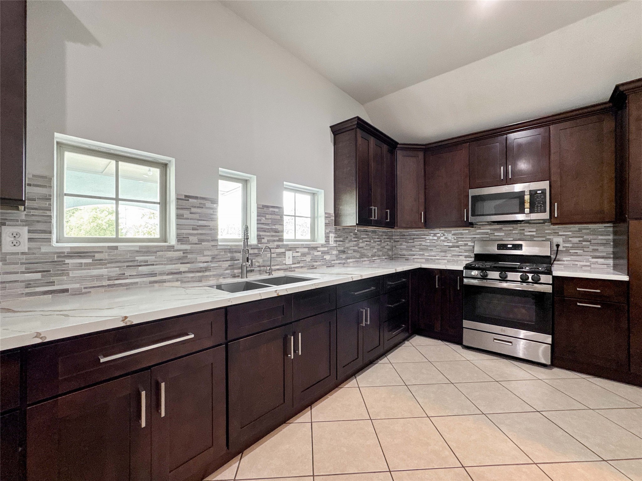 1060 County Road 5021 Cleveland, TX 77327 - Photo 7 of 34 a kitchen with stainless steel appliances granite countertop a stove sink and cabinets