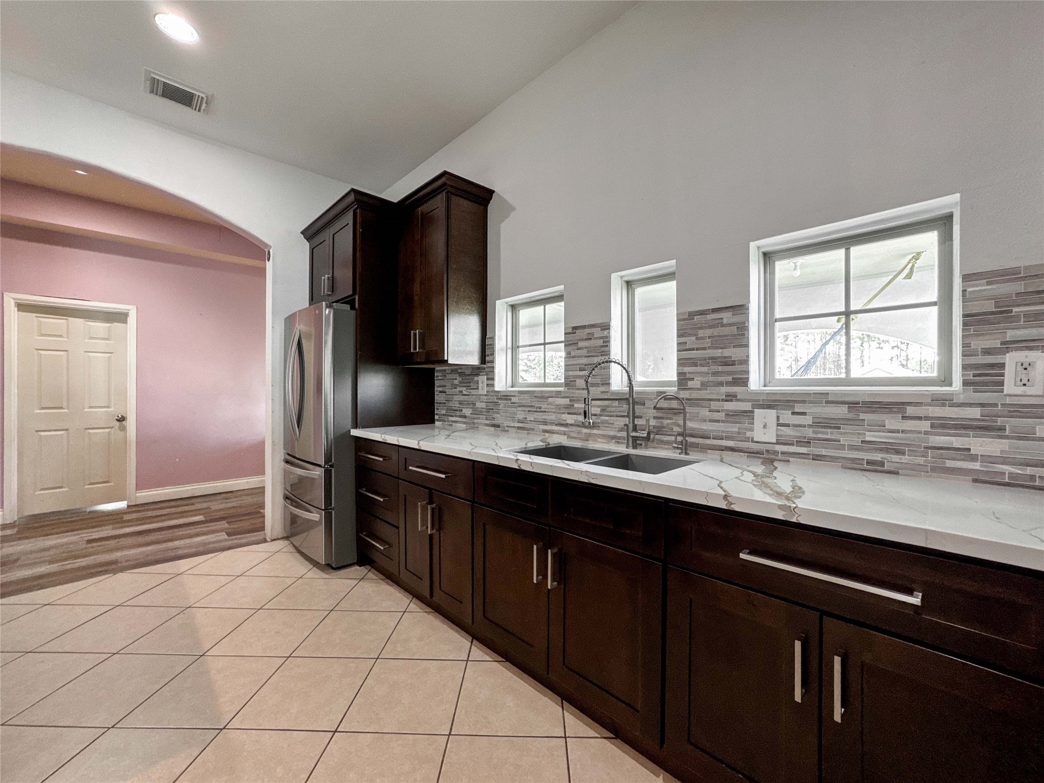 1060 County Road 5021 Cleveland, TX 77327 - Photo 9 of 34 a kitchen with stainless steel appliances a sink and a refrigerator