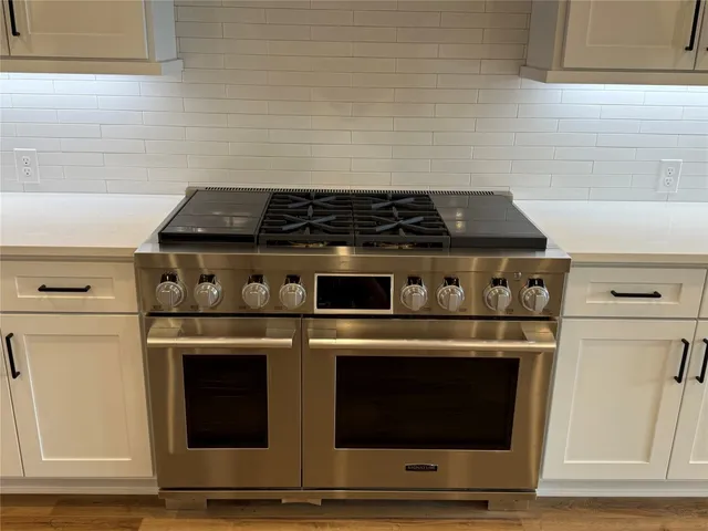a stove top oven sitting inside of a kitchen