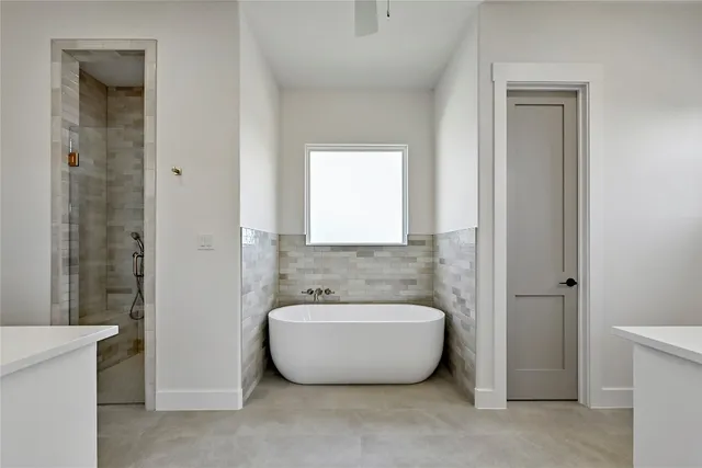 a spacious bathroom with a bathtub and shower
