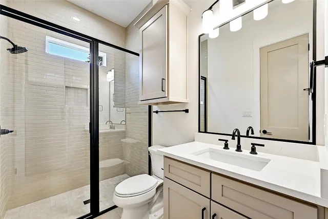 a bathroom with a sink toilet and shower