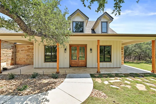 a front view of a house with garden