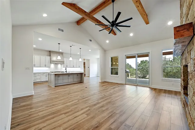 a view of a kitchen with a sink and wooden floor