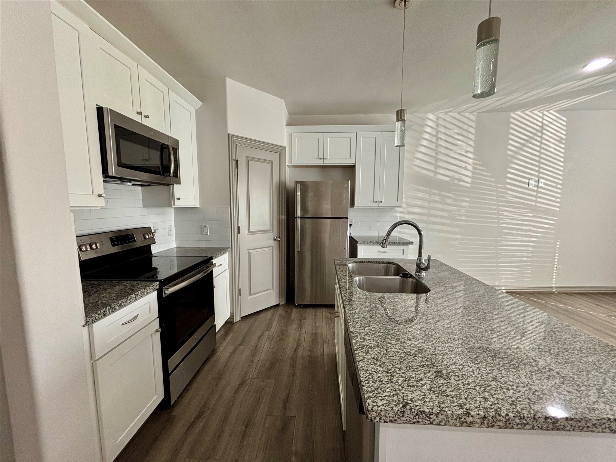 8918 Southview Street, Unit A Houston, TX 77051 - Photo 2 of 14 a kitchen with stainless steel appliances granite countertop a stove refrigerator sink and microwave