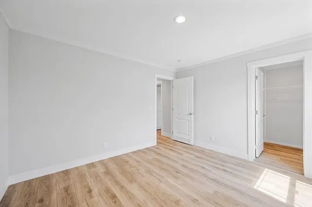 a view of an empty room and wooden floor