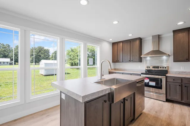 a kitchen with kitchen island a sink stove and wooden cabinets